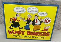 Front view of Wimpy Burgers metal sign showing graphics and text