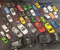 Group shot of all toy cars on couch showing quantity and variety