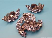 Front view of brooch and earrings showing lavender crystals