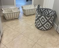 Overview showing two wire baskets with liners and one woven basket