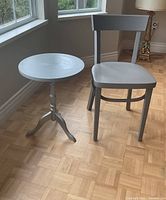 front view of grey chair and round side table
