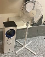 Tower and pedestal fans side by side