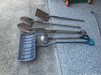 All six tools laid out: four digging shovels, one lawn edger, one snow shovel