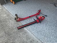 Full view of trimmer showing cord, body and blade guard