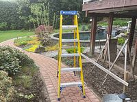 Full view of Louisville fiberglass ladder in garden