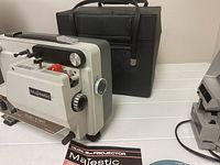 Projector next to carrying case