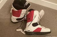 Pair of Forum snowboard boots on carpet showing outer sides and branding