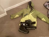Full view of Lamar jacket and snow boots on floor