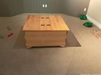 Top view of closed pine storage box showing split lid and hinges