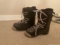 Side view of both boots showing uppers, laces, and logos