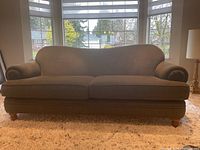 Front view showing overall design, cushions, arms, feet