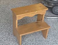 Front view of solid wood two-step stool