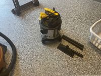 Stanley shop vacuum with accessories on floor