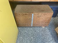 Closed plywood tool box bench showing carpeted top and lockable front panel