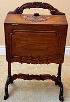 Front view closed cabinet on carved stand