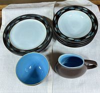 Stacked dinner plates, bowls, creamer and small bowl overview