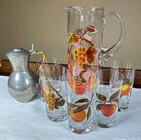 Glass pitcher, several tumblers, pewter pitcher grouped