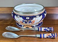 Bowl front view with two serving utensils