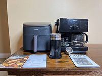 Front view of three appliances with manuals displayed