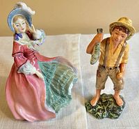 Front view of both figurines displaying overall form and colour