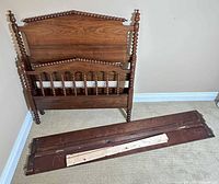 Headboard, footboard, support slats shown leaning against wall