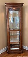 Full front view of closed curved-front curio cabinet