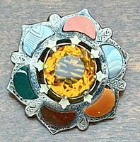 Top view of brooch showing center stone and agate petals