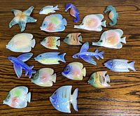 All 19 glazed ceramic marine figurines laid out