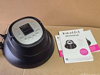 Lid with power cord and two manuals