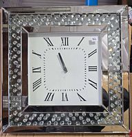 Front view of square mirrored wall clock