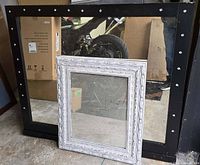 Front view showing both mirrors leaning against wall