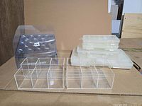 Group view of Fiskars display box, two acrylic organizers, stack of latching cases