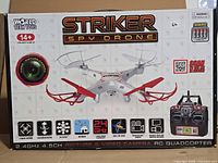 Front of retail box showing World Tech Toys Striker Spy Drone with controller and feature icons