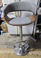 Full view of LumiSource bar stool at full height showing chrome base, footrest, walnut back, grey cushion