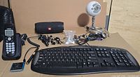 All items arranged: keyboard, VTech phone, JBL speaker, Blue mic, iPod, assorted cables