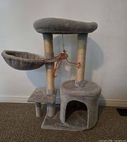 Front view of entire grey cat tree showing hammock, posts, perch, cubby