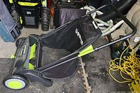 Side view of Earthwise LSW70021 lawn sweeper showing frame, bag, wheels