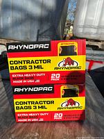 Front view of two stacked Rhynopac contractor bag boxes showing capacity and thickness