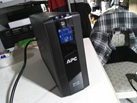 Front view showing APC logo and LCD reading 121 V