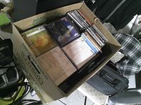 Open box showing stacks of CDs in jewel cases