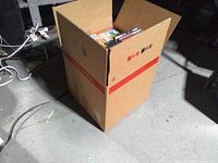Full cardboard box with movie discs visible at top
