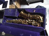 Saxophone in open purple-lined hard case