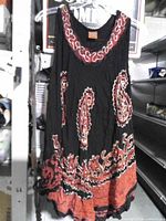 Front view of black sleeveless top with red embroidery on hanger