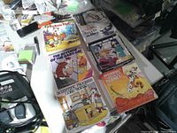 Six Calvin and Hobbes paperback books laid out on table showing cover art and condition