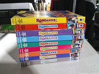 Stack of eight colour-coded Roseanne DVD season box sets