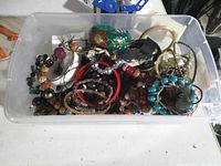Top view of bin showing mixed costume jewellery pieces