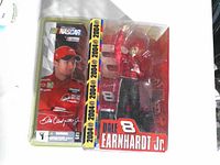Front of sealed blister pack showing figure, driver photo card, NASCAR Action logo, 2004 strip