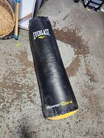 Full view of Everlast PowerCore punching bag lying on floor