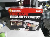 Front of retail box showing Sentry Fire-Safe Security Chest model 1100