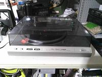 Turntable with dust cover closed showing overall exterior condition and front control panel